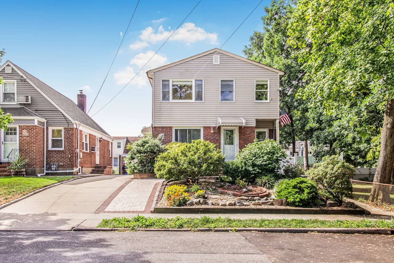 Residential home in Michigan with landscaped yard, showcasing brick and siding exterior, emphasizing property safety and health considerations for radon testing.